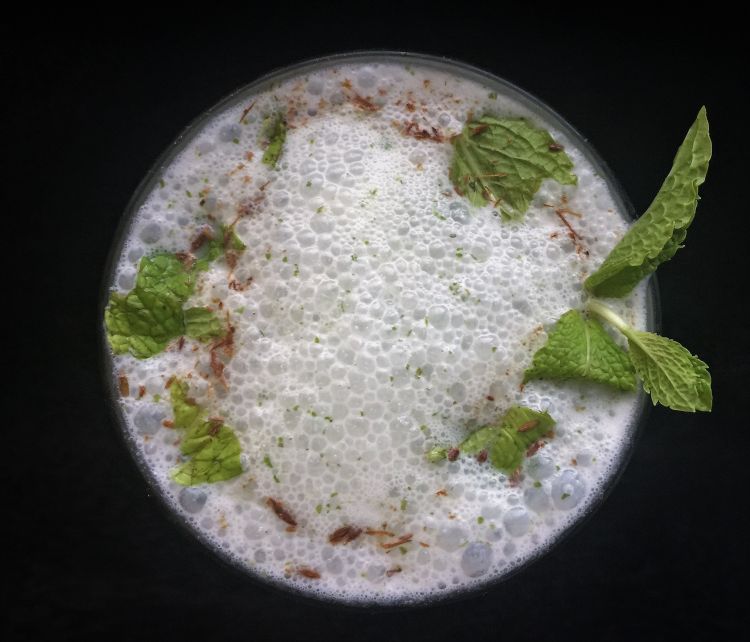 Close up view of Mint buttermilk garnished with fresh mint leaves and cumin powder, How to make Mint Buttermilk