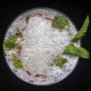 Close up view of Mint buttermilk garnished with fresh mint leaves and cumin powder, How to make Mint Buttermilk