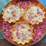 overhead image of Bread Rasmalai, garnished with almonds, dry rose petals, served in golden bowls and presented in a Brass Platter, How to make Instant Bread Rasmalai