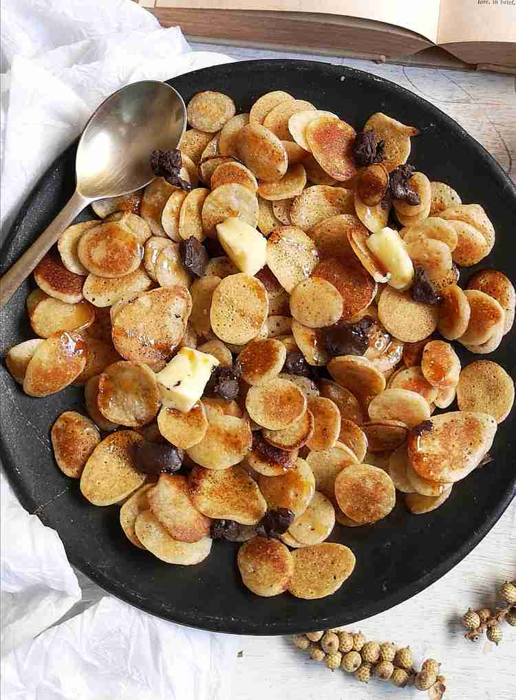 close up view of Cereal Pancakes drizzled with honey and served with butter and chocolate bites