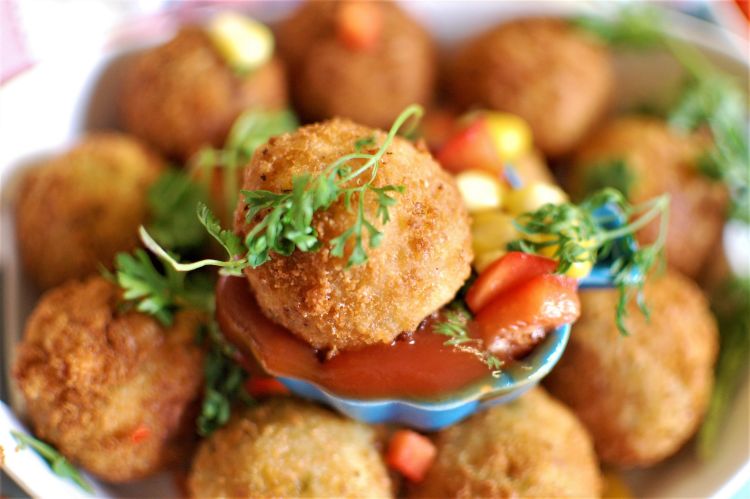 Corn Cheese Balls served with tomato ketchup and garnished with coriander leaves