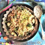 close up view of Sabudana Khichdi garnished with finely chopped coriander leaves, cucumber and capsicum salad