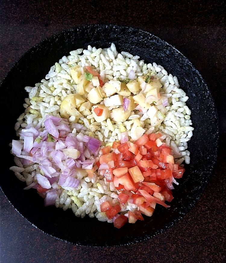 adding boiled potatoes, chopped onions, tomatoes to roasted puffed rice, how to make street style bhel puri at home