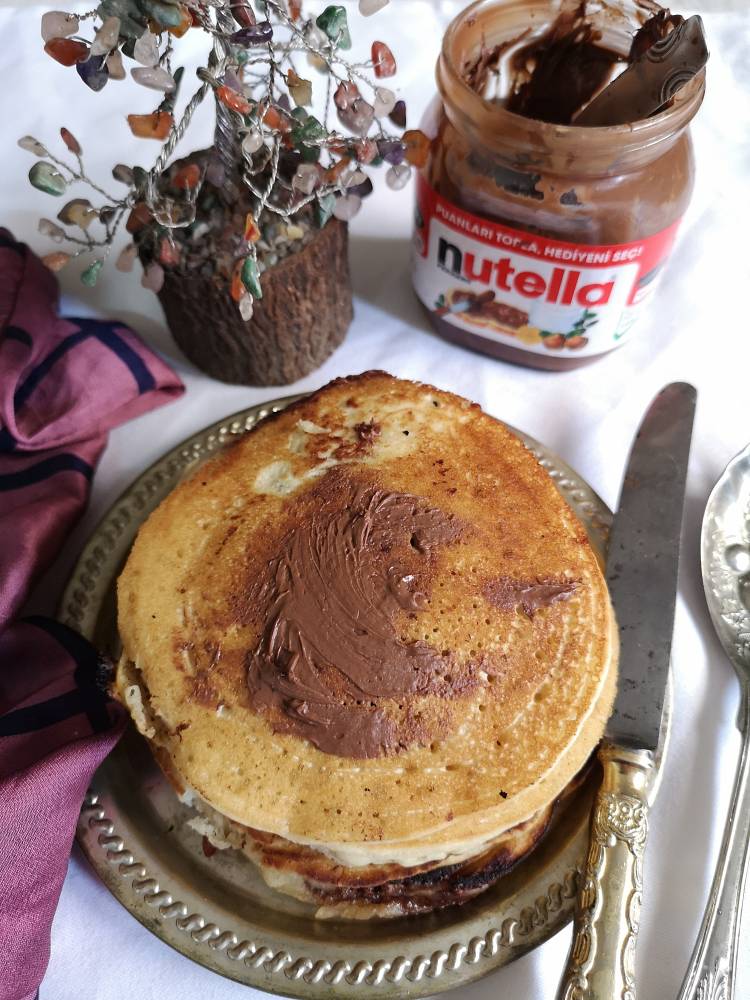 Delicious Nutella Pancakes with Nutella spread on top of it