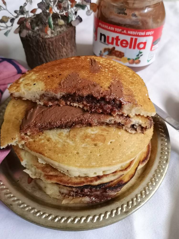 Nutella oozing out from pancakes when cut into half , stack of nutella pancakes recipe