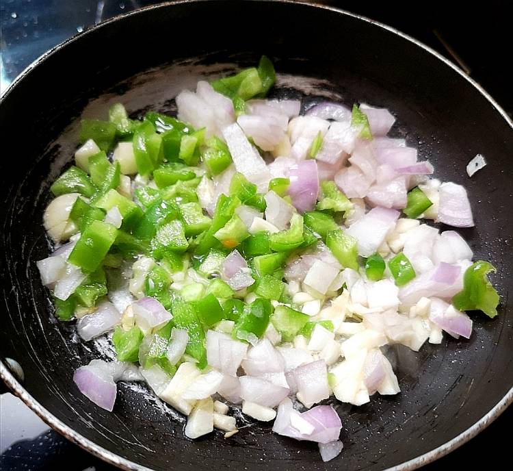sauteing chopped onions and capsicum in oil for veg kabab
