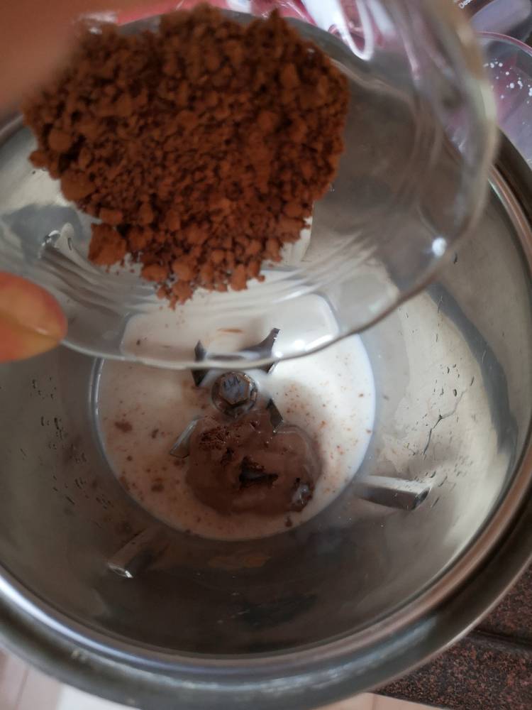 blending coco powder, chocolate ice cream to the blender for Chocolate Milkshake