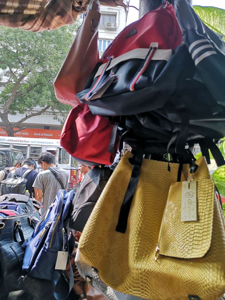 blog on Colaba Causeway Shopping Tips and Tricks, artificial leather bags, backpacks, slings, purses displayed at Colaba Causeway, Street Shopping at Colaba Causeway, Mumbai