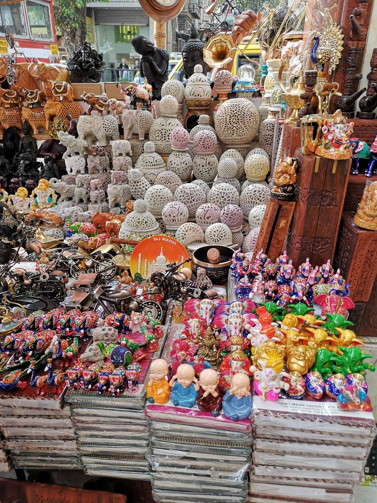beautiful marble and wooden decor items, antiques, ganesha idol, laughing buddha, taj mahal show piece, mosaic lamps being displayed at colaba causeway market in mumbai