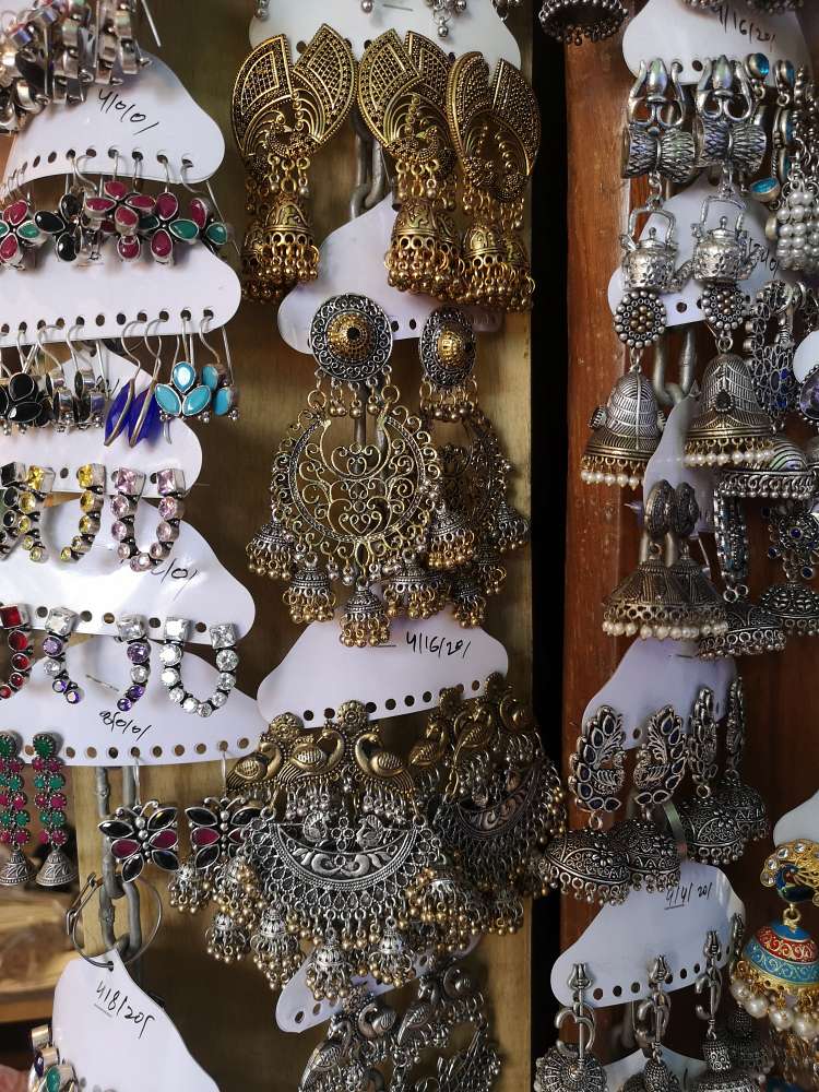 gold, silver, antiques and small earrings displayed at colaba causeway market in mumbai
