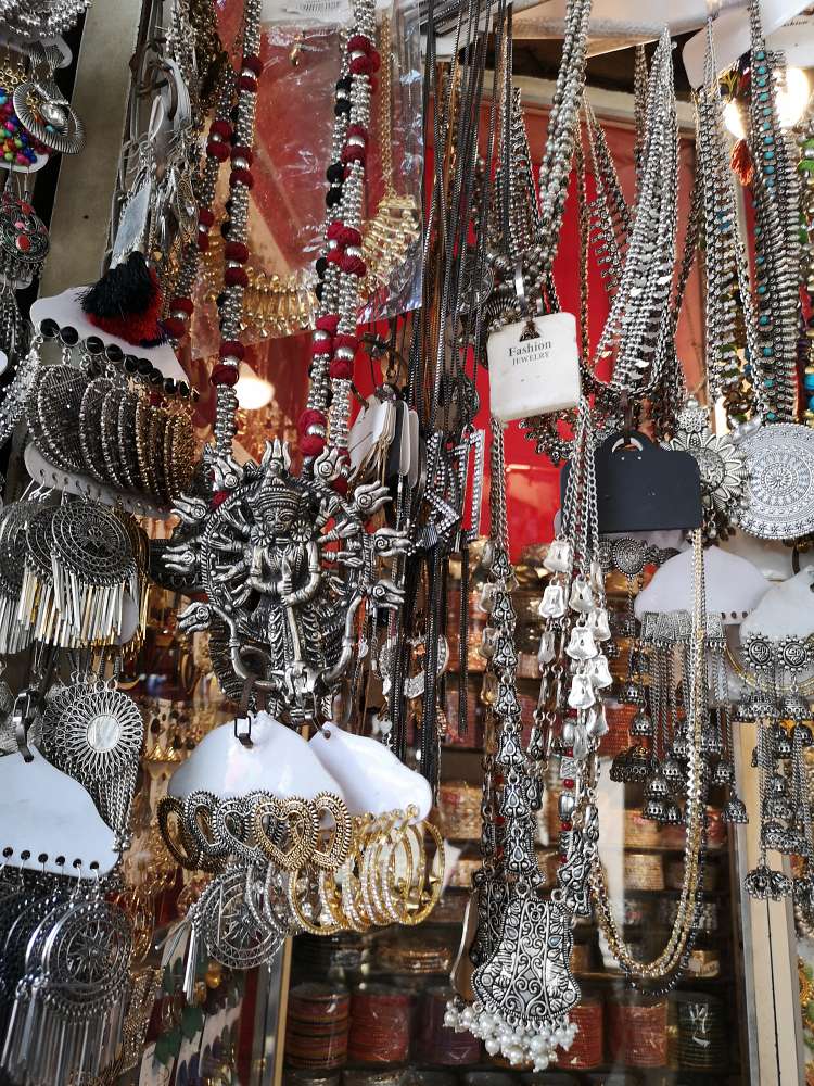 boho neck pieces, silver earrings, silver necklaces, displayed at Colaba Causeway market