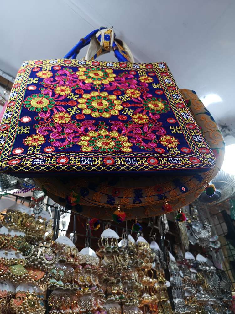 blog on Colaba Causeway Shopping Tips and Tricks, colorful hand embroidered tote bag displayed at Colaba causeway