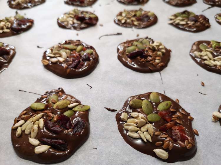 mini detox chocolate bites topped with sunflower seeds, pumpkin seeds, cranberry and flax seeds
