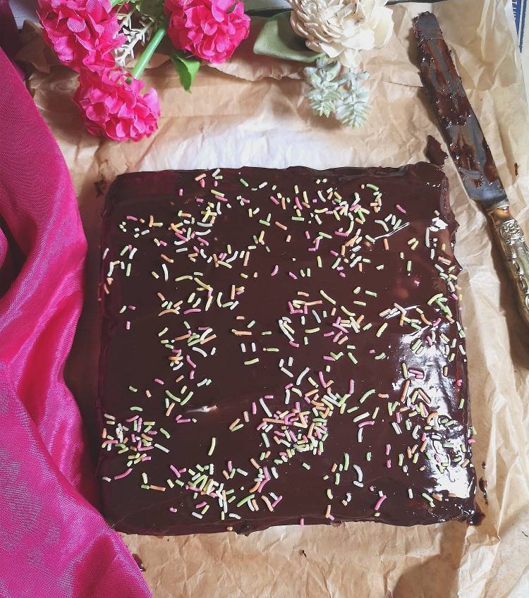  overhead photo of Chocolate Ragi, Nachni Cake with chocolate Ganache and colourful sprinklers,, how to make Chocolate Ragi Cake, Recipe of healthy Nachni Chocolate Cake