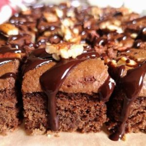 close up view of egg less pecan nuts brownie drizzled with chocolate ganache, how to make pecan nuts brownie