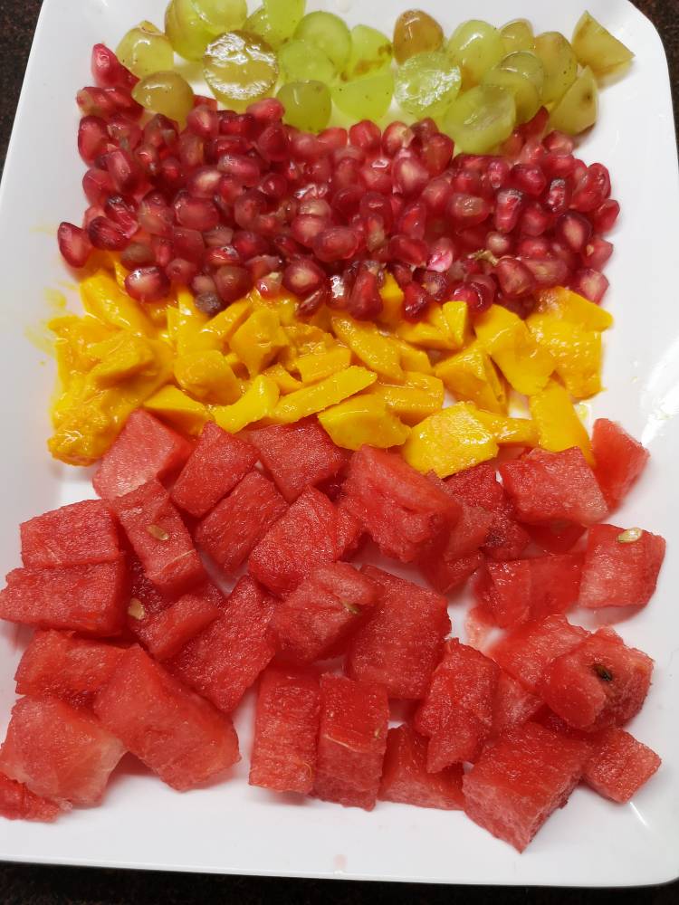 small chunks of watermelon, grapes, pomegranates and grapes for fruit cream