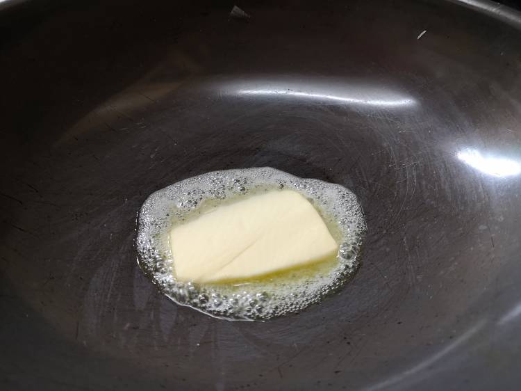 Adding butter for Paneer Butter Masala Recipe