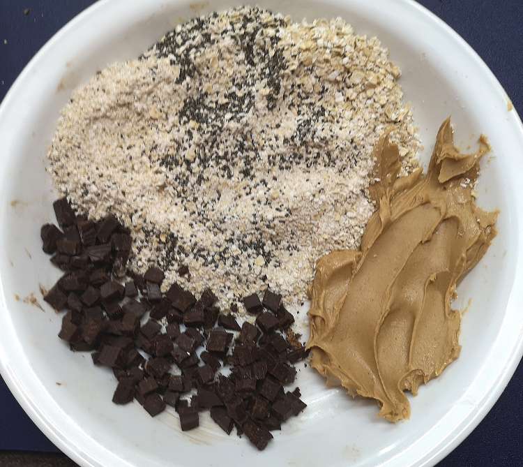 chocolate chips, oats, flax seeds and peanut butter on a white plate