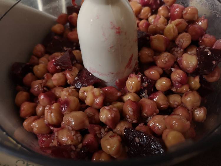 transferring white chickpeas, beetroot and sesame seeds into a food processor