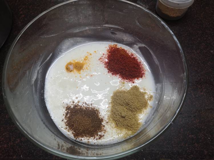 Adding turmeric powder, red chili powder, coriander powder, cumin powder to hung Yogurt , recipe of tawa paneer masala, how to make Tawa Paneer