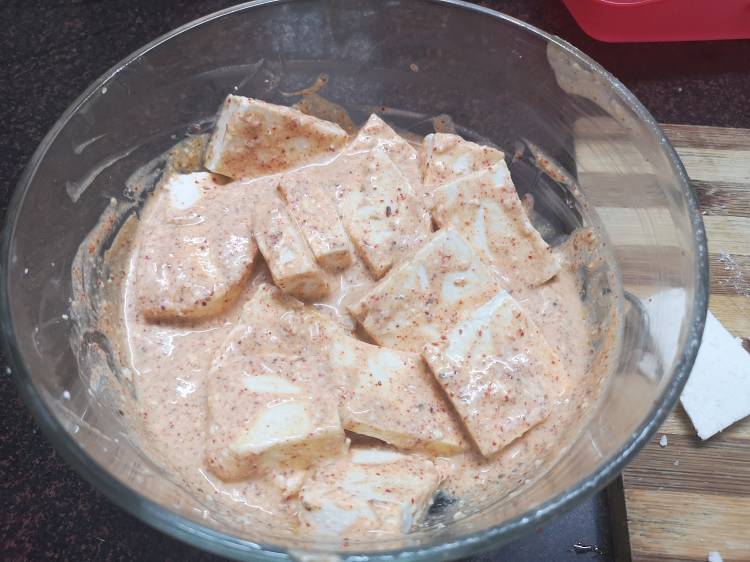 marinating paneer cubes in yogurt with spices like turmeric powder, red chili powder, coriander powder, kasuri methi for tawa paneer masala 