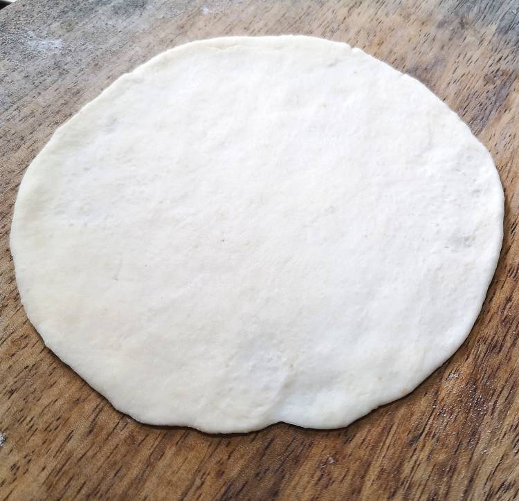 rolling Bhatura into a circle or an oval shape