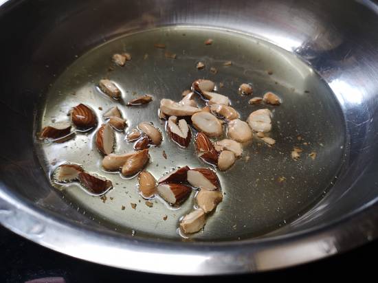 Roasting almonds for Rajgira Sheera Recipe , how to make rajgira flour sheera for vrat