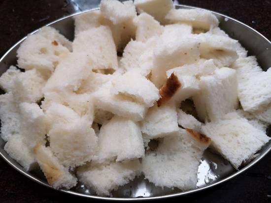 cutting bread pieces for Upma recipe, South Indian Style Bread Upma