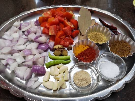 onion, tomato, garlic, ginger, green chili and spices for chole recipe