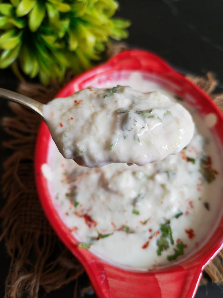 close up look and a spoonful of vrat wale cucumber raita recipe and a
