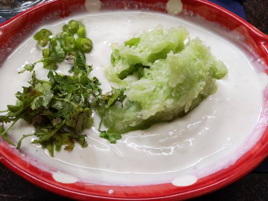now adding green chilies and coriander leaves in cucumber raita recipe / Recipe of cucumber raita / how to make cucumber raita