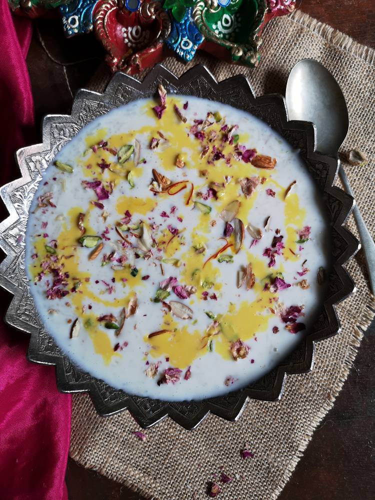 doodh pak recipe, doodh pak served in a silver bowl garnished with almonds, pistachios and kesar milk 