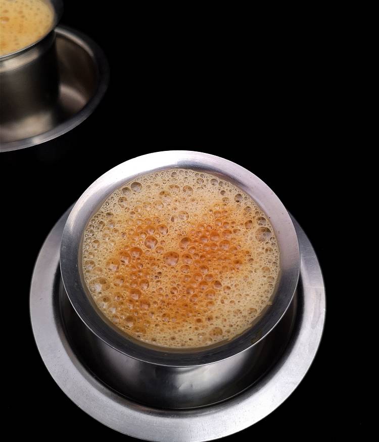 how to make South Indian Filter coffee recipe at home, close up view of strong, frothy filter coffee served in steel tumbler