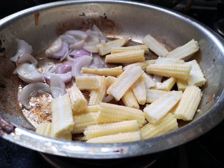 sauteing onion and baby corn for kadai baby corn recipe with kadai masala