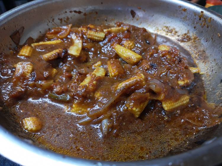 simmering in gravy for kadai baby corn recipe with kadai masala