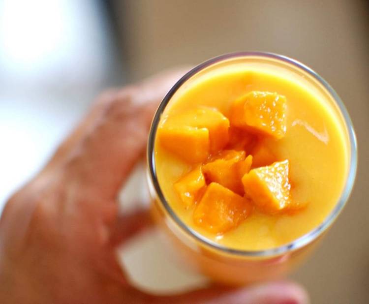 close up view of Mango Milkshake with mango chunks