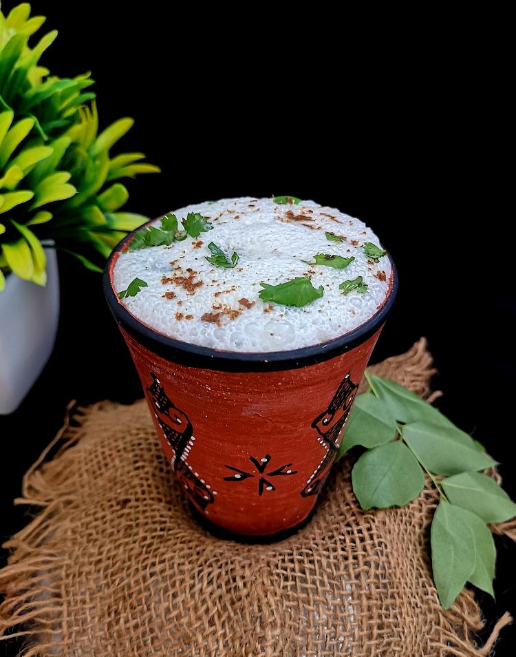 close uo photo of Masala Buttermilk with finely chopped coriander leaves and cumin powder., Benefits of Buttermilk, How to make Masala Chaas