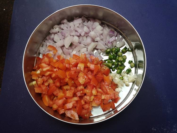 finely chopped onions, tomatoes, green chilies and garlic for palak paneer bhurjee