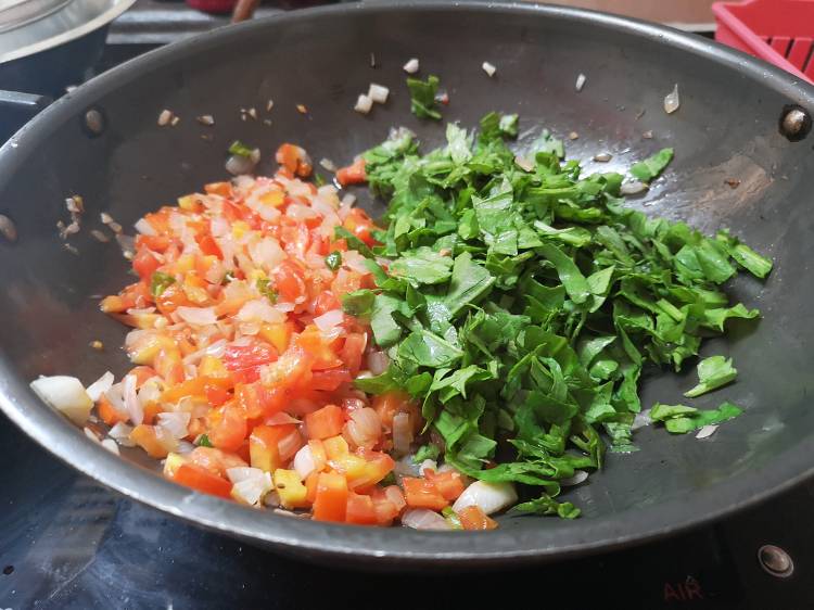 close up view of chopped tomatoes and spinach being cooked, recipe of paneer palak bhurjee