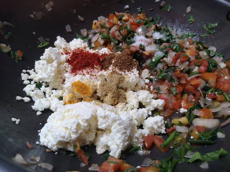 adding crumbled paneer, red chili powder, turmeric powder and garam masala for palak paneer bhurjee 