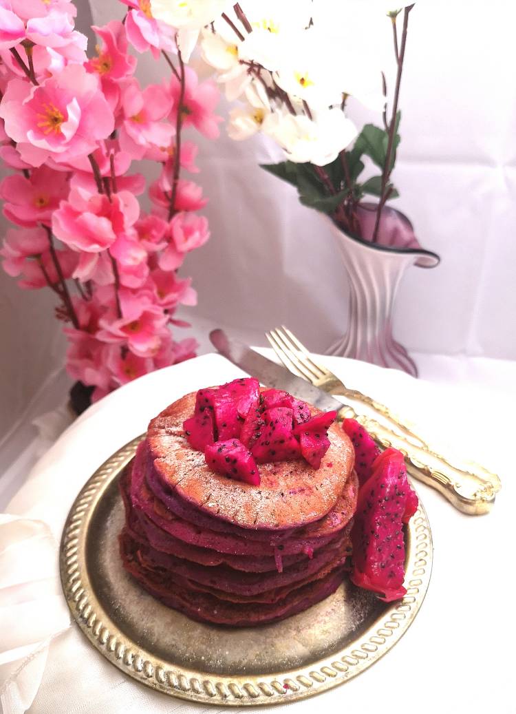 Stack of pink pitaya pancakes , Dragon fruit pancakes served on a brass plate with knife and a fork, Recipe of Dragon Fruit Pancakes ,Pink Pitaya Pancakes recipe 