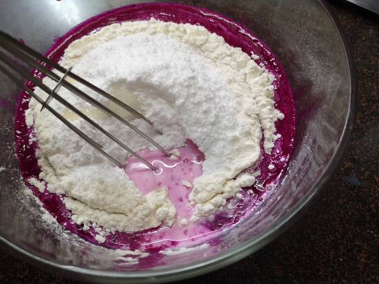 whisking all the ingredients of pancake batter of Pink Pitaya Pancakes Recipe , Dragon Fruit Pancakes Recipe