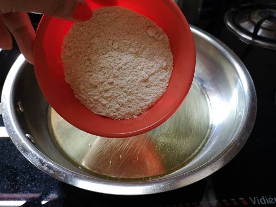 Roasting Amaranth flour in melted ghee for Rajgira Sheera Recipe,  how to make rajgira flour sheera for vrat 