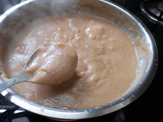 taking a spoonful of rajgira sheera to see if its cooked,  how to make rajgira flour sheera for vrat