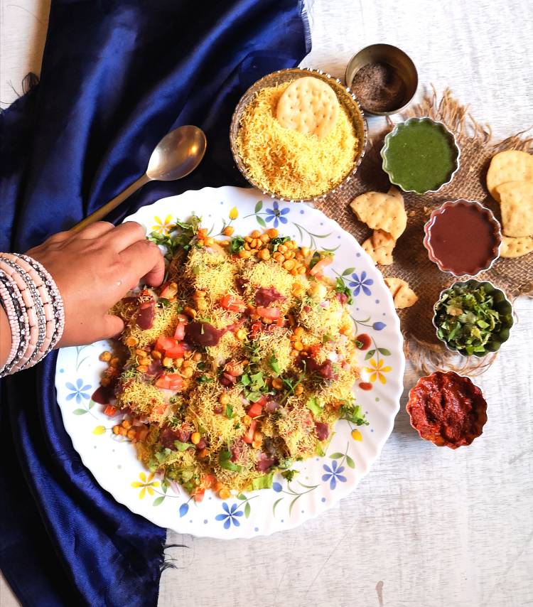 Sev Puri served with dates, coriander, garlic chutney along with papdis and nylon sev