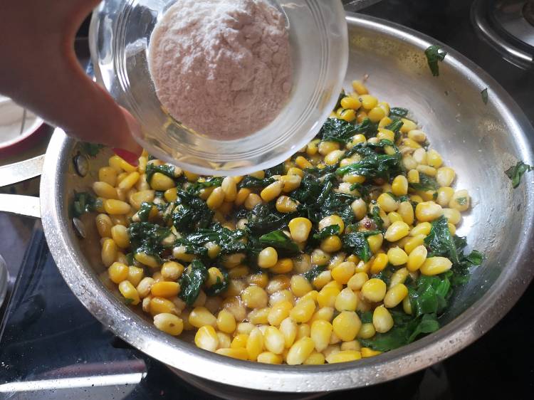 mixing all-purpose flour to cooked spinach and sweet corn