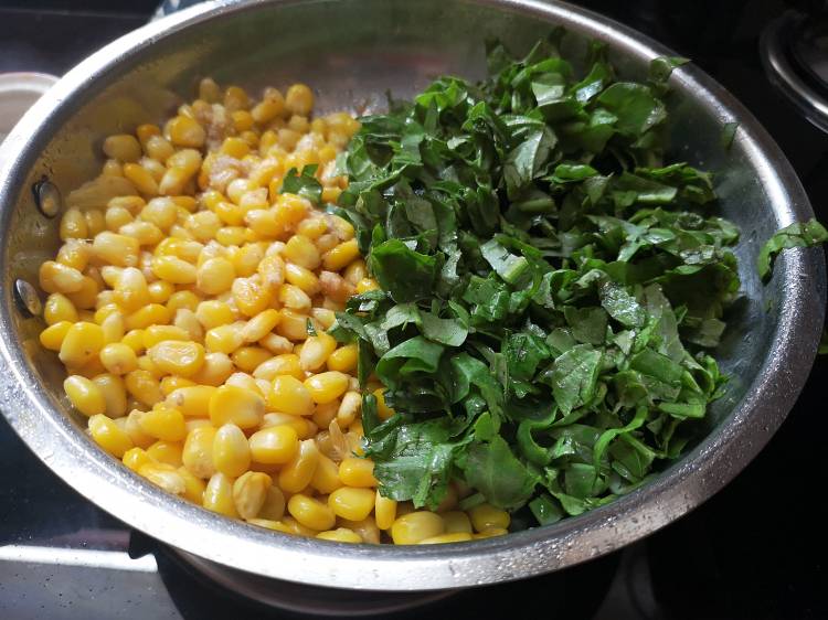 adding chopped spinach leaves to the boiled sweet corn. how to make spinach corn grilled sandwich