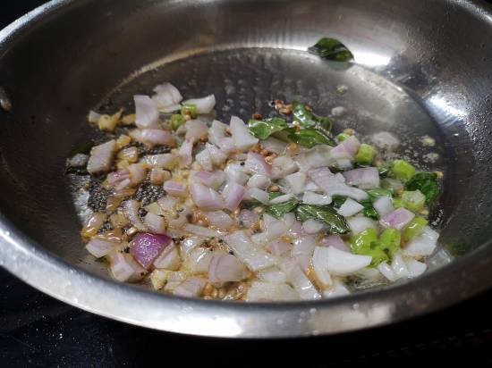 adding onions in the pan for preparing tomato bhaat , how to make tomato rice