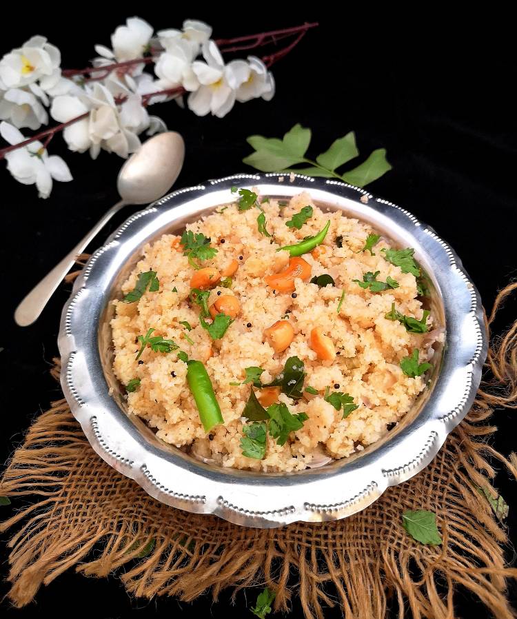 Upma Recipe for Breakfast / Upma garnished with coriander leaves, cashew nuts and served in a steel bowl