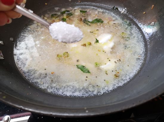Adding sugar to boiling Rava and Yogurt mixture for  upma recipe
